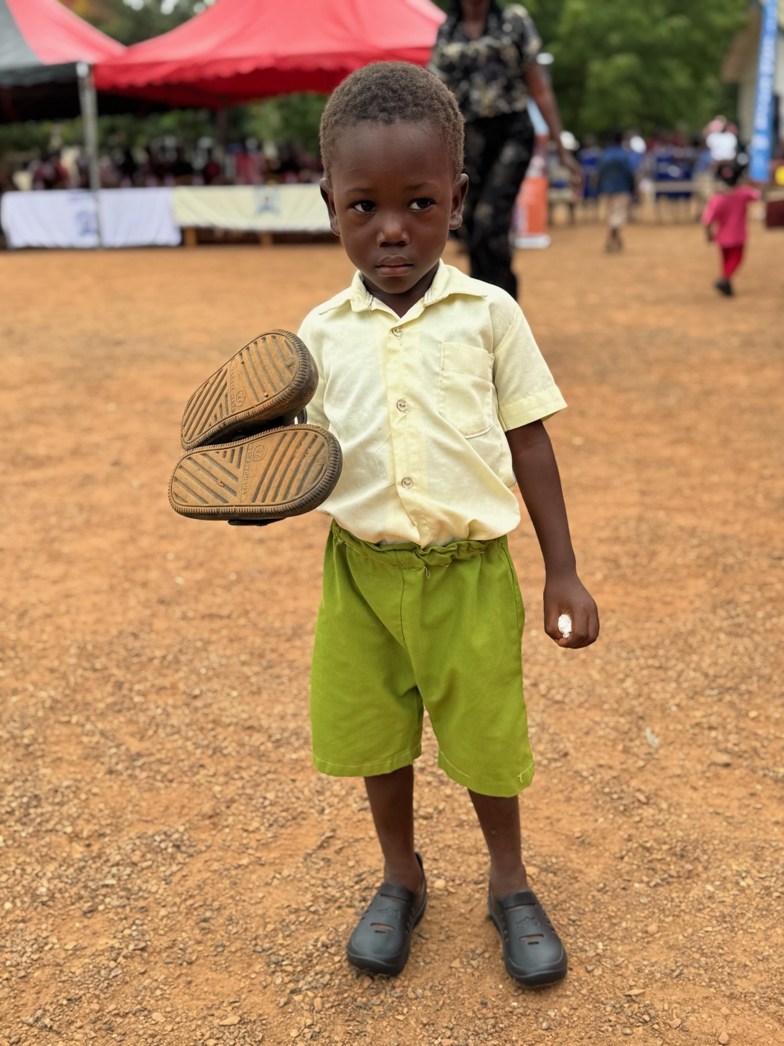 Child holding shoes